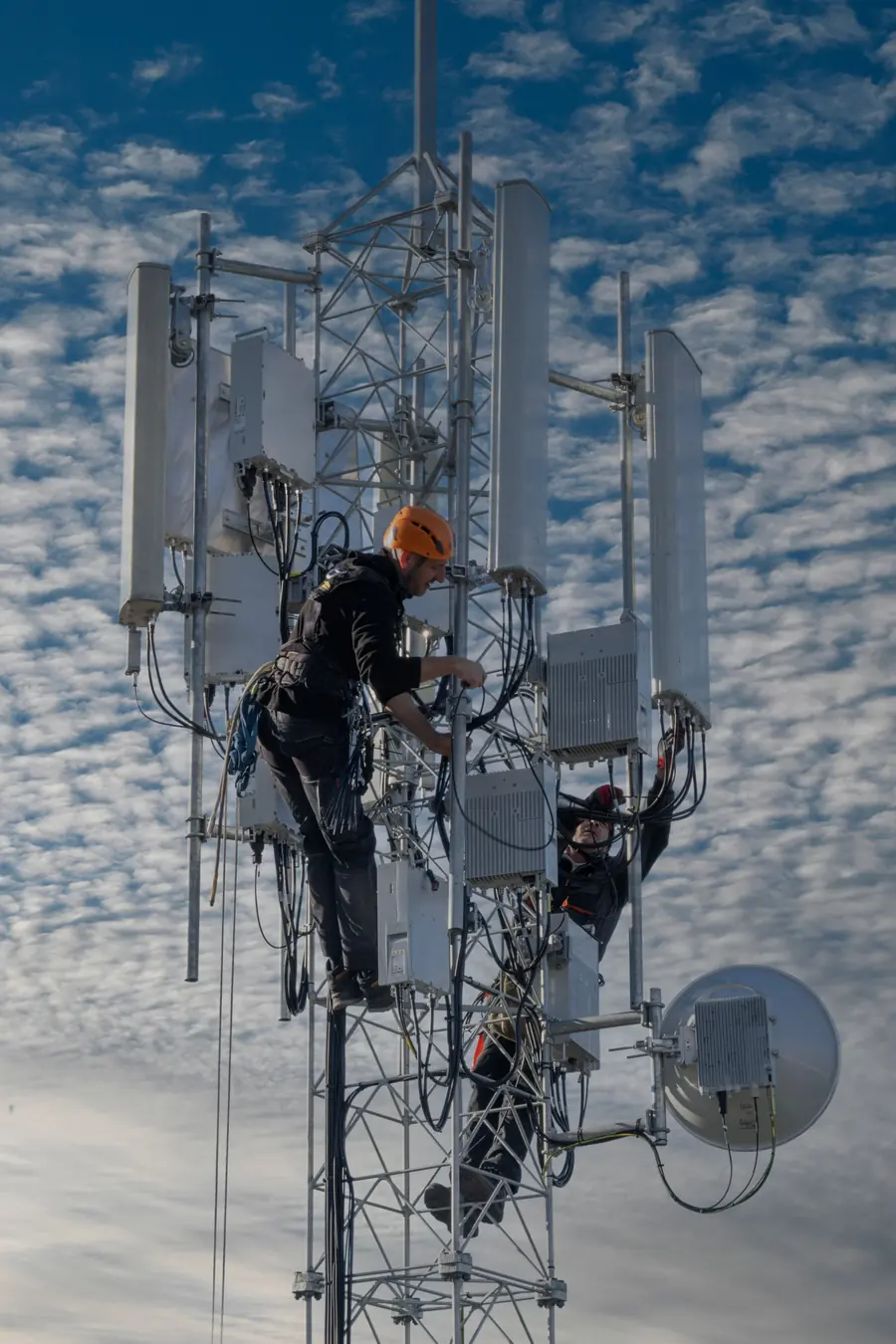 Techniciens qui travaillent sur un pylône de télécommunication